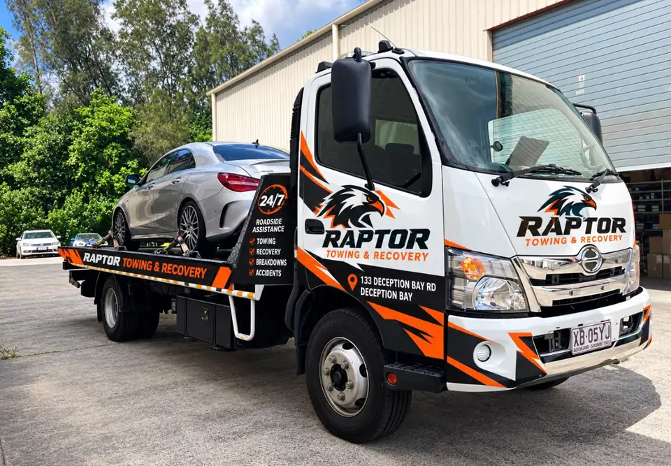 Car strapped onto the Raptor Towing tilt tray
